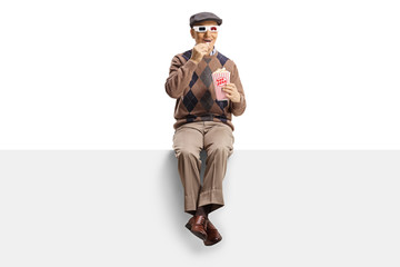 Elderly man on a panel with popcorn and 3d movie glasses