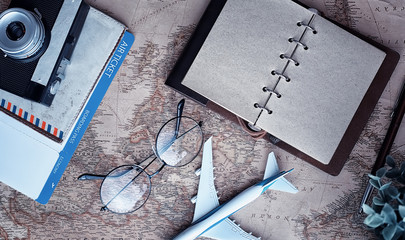 Travel concept. Map on the table andl aircraft.