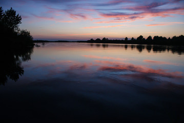 Reflection of the sunset sky in the river in the summer.