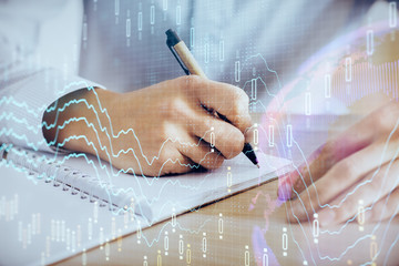 Multi exposure of man planing investment with stock market forex chart.