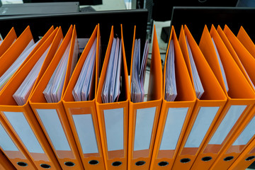 Document binder file folders stack on office desk in organization with report paper, paperwork record label, A lot of work information for businessman or lawyer organized archive database bookkeeping
