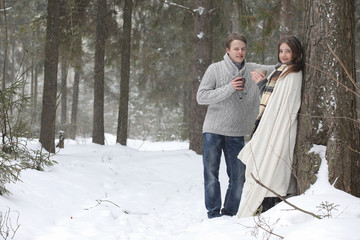 pair of lovers on a date winter afternoon in a snow blizzard