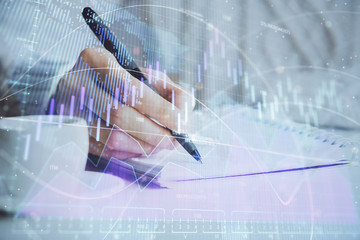 Forex chart displayed on woman's hand taking notes background. Concept of research. Double exposure