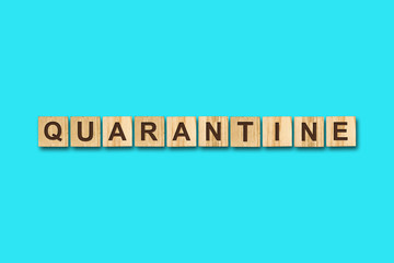 Quarantine. The inscription on wooden blocks on a blue background. Viruses. Epidemic.