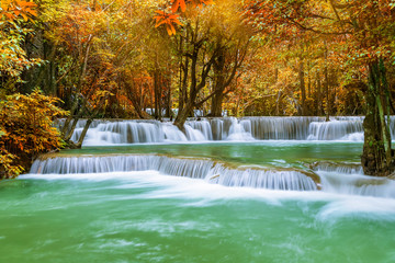 Colorful majestic waterfall in national park forest during autumn - Image