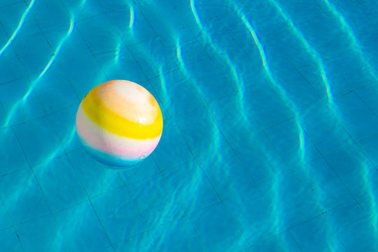 ball pool side floating on water background surface summer time bright day vacation season concept wallpaper pattern picture with empty copy space for your text here