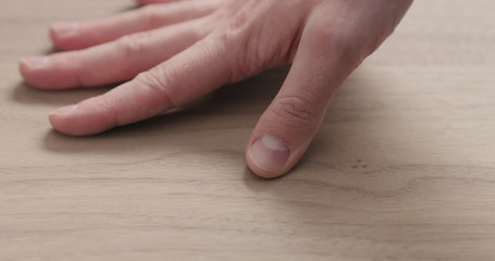 man hand touches black walnut board