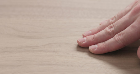 man hand touches black walnut board