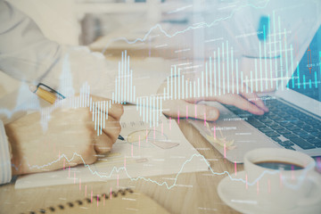 Multi exposure of stock market graph with man working on laptop on background. Concept of financial analysis.