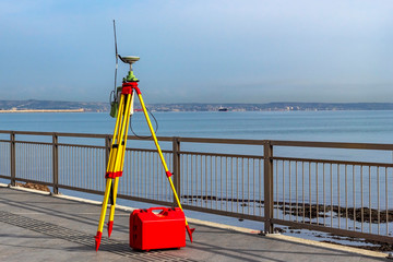Theodolite measuring instrument. Modern geodetic device on the quay. The process of preparing the...