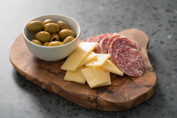 Italian traditional antipasti appetizers on olive wood board