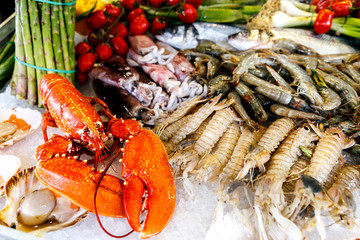 White-headed sea fish, shrimp, crabs, crayfish, mollusks, lobsters are on ice
