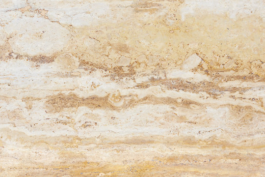 Polished surface of beautiful sand-colored Travertine. Background image, texture.