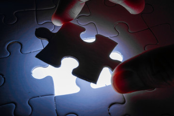 Missing piece of jigsaw puzzle with light glow, business concept for completing the final puzzle...
