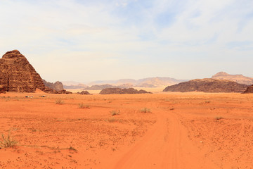 Fototapeta na wymiar Wadi Rum desert panorama with dunes, mountains and sand that looks like planet Mars surface, Jordan