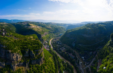 Fototapeta na wymiar The city of Chiatura and the Mining plant and manganese ore processing plant located in the gorge of the Kvirila River, a tributary of the Rioni and on adjacent plateaus.