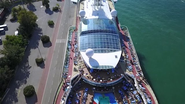The cruise ship and the port from the sky. A beautiful and very intersting ship. 
Piraeus city from Greece.
A sunny day in a tourist period.
Very nice drone shot from above.