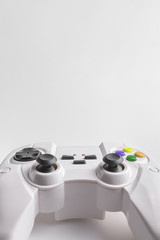 White wireless gamepad for playing video games. Joystick on a white background. Game controller close up.