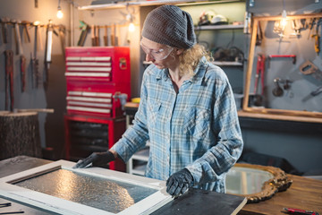 Carpenter working on the old wood in a retro vintage workshop.