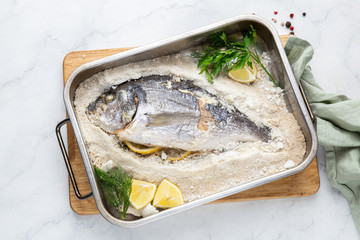 delicious  salt-baked dorada fish with lemon and herbs