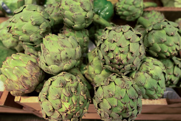 Fototapeta premium Fresh green artichoke in wooden box on the market