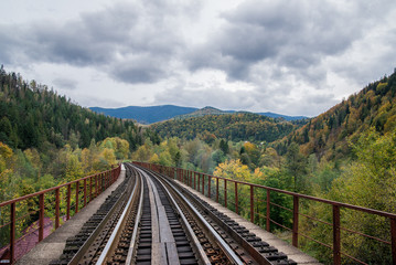 Fototapeta na wymiar railroad in the mountains in the forest on a journey in nature