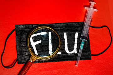 A medical mask with an inscription "FLU" on red background 