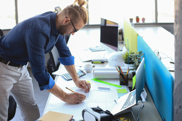 Shot of a handsome male architect working on a design in his office.