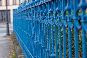 Blue metal fence in the city, Germany.