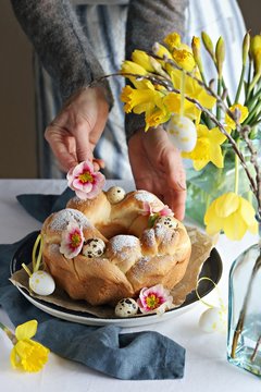 Easter wreath. Osterkranz. Germany traditional Easter cake decorated with quail eggs and fresh flowers.