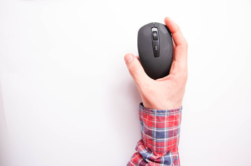 Wireless, bluetooth black mouse in male hand on a white background. Hand sideways, straight, hand...