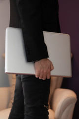 Unrecognizable businessman with laptop.