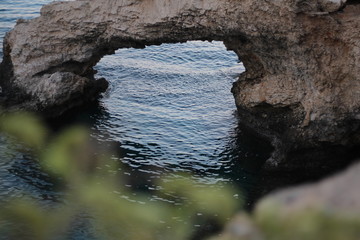 bridge of lovers made of stones in the Mediterranean sea