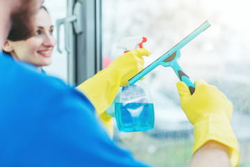 Commercial cleaners cleaning an office window