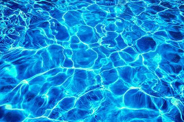 Fototapeta na wymiar Abstract dark blue clear water in swimming pool. Neon light water effect.