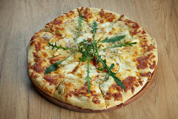 Close up view on Appetizing 4 cheese pizza with pear on wooden background in a restaurant. Pizza in composition. Italian cuisine. Food flat lay