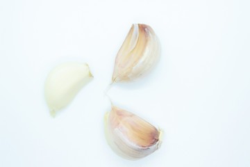 Peeled garlic cloves located on a white background