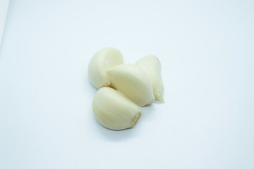 Peeled garlic cloves located on a white background