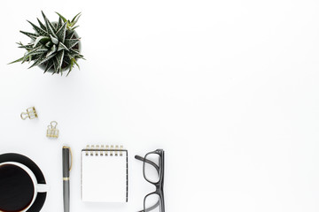 Notepad pen glasses coffee cup modern business background with copy space for your text. Top view, flat lay.