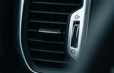 Climate control air conditioner in a new car close-up. Modern car interior details.