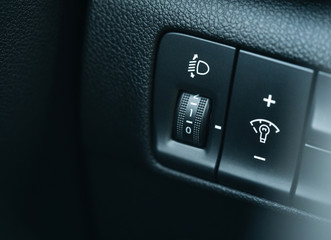 Closeup car dashboard button headlights. Texture and management Inside the car.