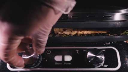 Delicious juicy meat steak cooking on the grill. Cook grilling fresh chicken breast. Fry chicken fillet on electric roaster. Slow motion.