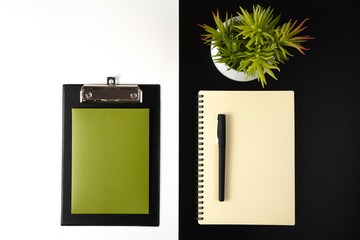 Desktop view from the top with stationery, Notepad and flower, a concept for business, environmental protection.