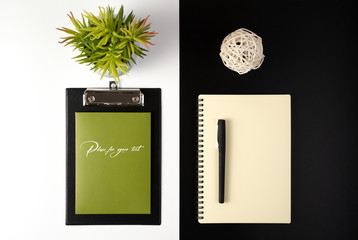 Desktop view from the top with stationery, Notepad and flower, a concept for business, environmental protection.