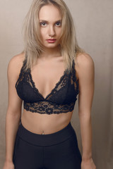 Young blond woman in lacy black lingerie