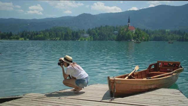 Girl taking pictures of Lake Bled in Slovenia