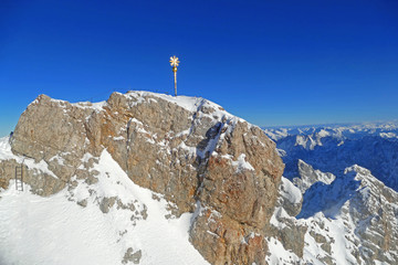 Zugspitze mountain is the highest point of Germany. Scenic view with summit cross