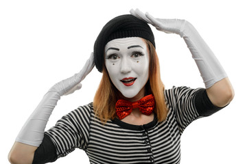 Woman tries on new hat. A pantomime sketch, performed by a female mime artist
