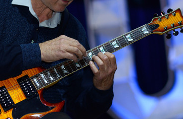 Guitarist hands playing the guitar using tapping techinique