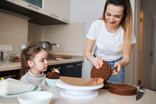 hardworking woman and her child making tasty cake for her husband. family prepearing for holiday, birthday party. close up photo